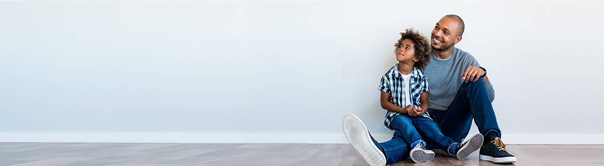 A man and his son sitting in a room.